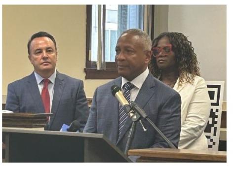 people speaking at a press conference